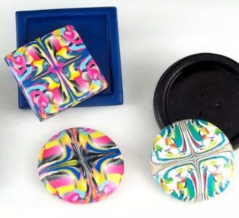 Examples of polymer clay cane work framed using Geometric CaBezel molds made by Carolyn Good