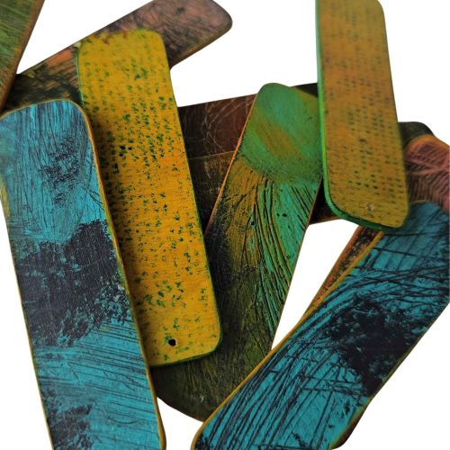 pieces of painted and textured wood ready to make earrings from