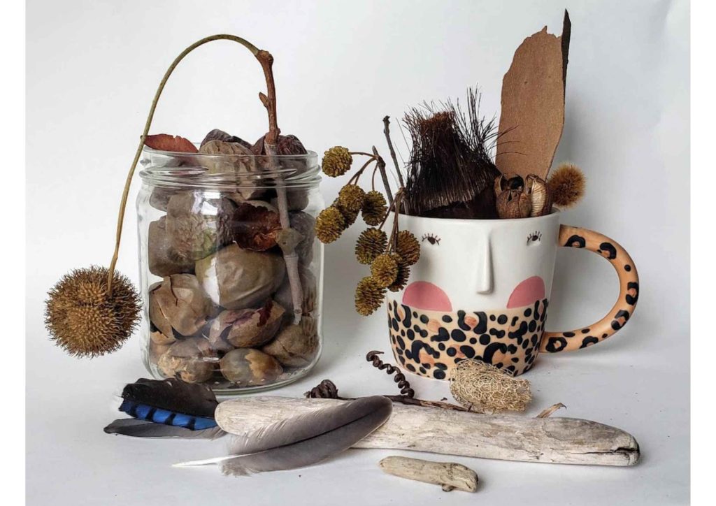 An image showing the artists personal collection of nature finds that she cherishes. Includes feathers, seeds sticks.