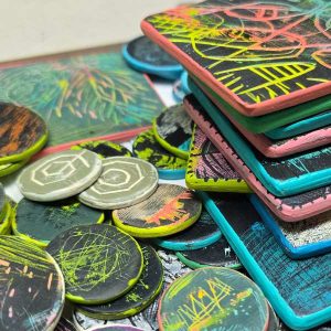 Several samples from the artists Scratching the Surface workshop using polymer clay, wood blanks and paint