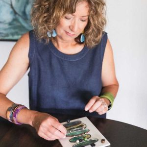 Wendy Orlowski looking at polymer clay jewelry pieces 