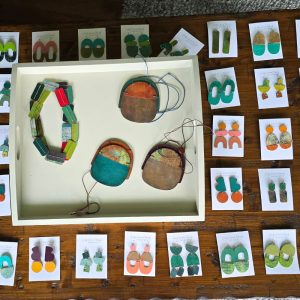selection of hand painted wood earrings on table